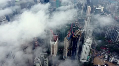 Drone shot morning low cloud over skyscraper building in KL city Видео 221740902