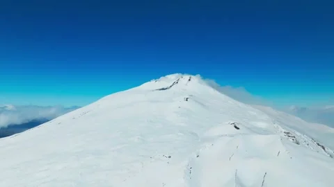 Drone Shot of Mount Etna, Snow Capped Volcanic Cone and Blue Sky on Sunny Day Vídeos de archivo 336625371
