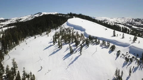 Drone Shot of Mountain Covered in Snow With Trees All Around 4k 스톡 동영상 235629565