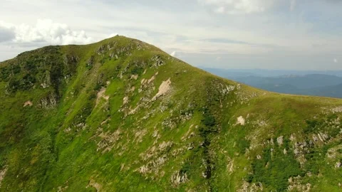Drone shot of mountain peak. Camera forward. Summer mountain landscape. Aeria Stock Footage 156253293