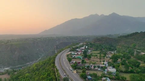 Drone shot of mountain road and Trikuta hills at golden hour.  Stock Footage 335639232