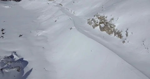 Drone shot of mountain road closed by snow near valley Stock Footage 104655283