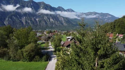 Drone shot, mountainous landscape of Austrian village, sky and clouds. Stock Footage 294349639
