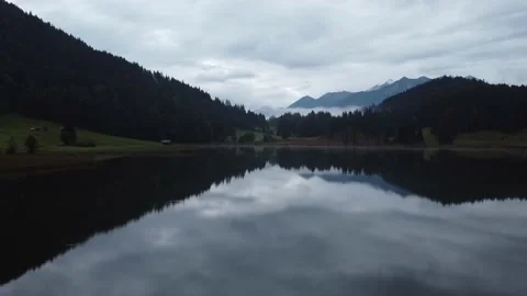 A drone shot of the mountains with beautiful reflection in the blue water Video stock 168065531