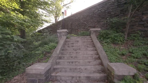 Drone shot moving along path and stairs in park Stock Footage 63294803