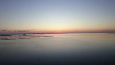 Drone shot moving fast across the sea bed, with the sun going down Stock Footage 231232033