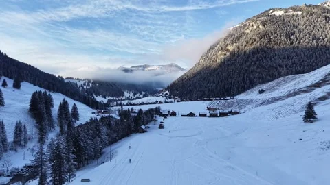 Drone shot moving forward with two skiers on a snowy winter trail 스톡 동영상 329506126