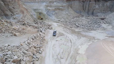 Drone shot of moving large mining dump truck. Top view of machine pulling up for 動画素材 219951120