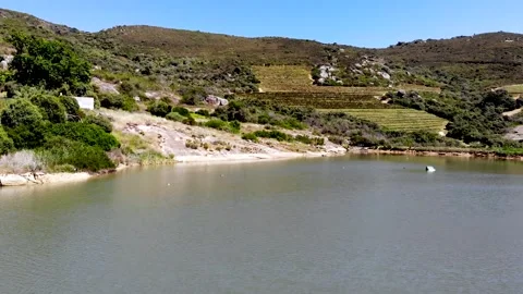 Drone shot moving over the dam on a farm Stock Footage 288218318