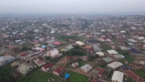 Drone shot moving towards homes in Ibadan Nigeria Stock Footage 258703076