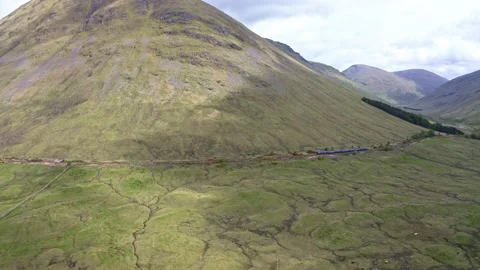 Drone shot of a moving train in the highlands of Scotland. Stock Footage 201211611