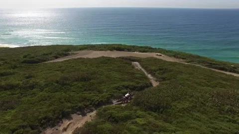Drone shot of MTB rider going down trail Stock Footage 235581542