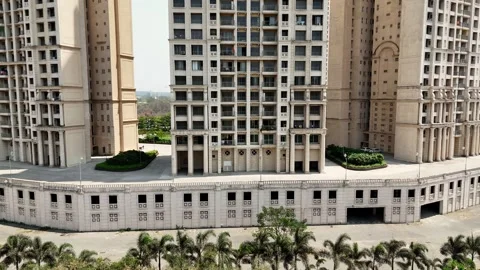 Drone shot multi story skyscraper above landscaped Stock Footage 311620440