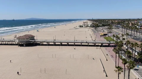 Drone shot of near empty beaches in Huntington Beach during Coronavirus pandemic Stock Footage 127980846