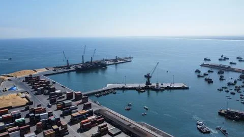 Drone shot of objects and cargo shops on a harbor under the blue sky Foto stock