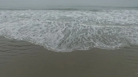 Drone shot of ocean sweeping over Beach with waves Stock Footage 54564932