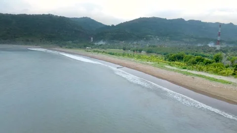 Drone Shot of Ocean Waves Along Cloudy Beach Stock Footage 326328857