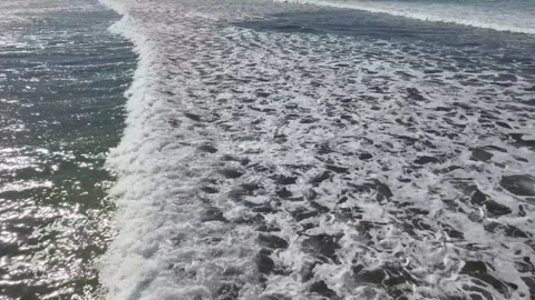 Drone Shot Ocean Waves Crashing Beach Video stock 205535948