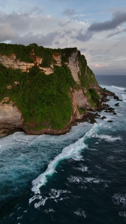 Drone Shot of Ocean Waves Crashing on Cliffs in Uluwatu, Bali Stock Footage 328719231