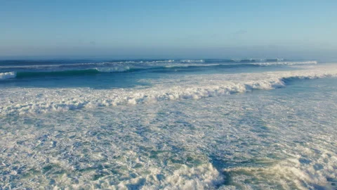 Drone shot of ocean waves crush in long surf Video stock 258827009