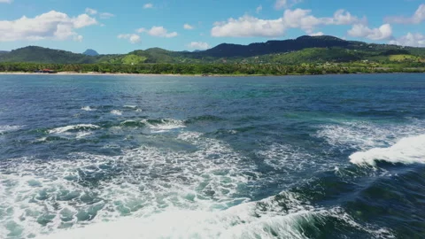 Drone shot of ocean waves rolling toward Saint Lucia's mountainous coastline Stock Footage 344987162