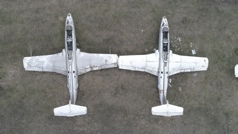 Drone shot of old L-29 airplanes at abandoned airport at Vovchansk, Ukraine Stock Footage 90743473