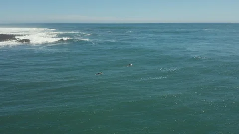 Drone Shot Orbiting 2 Surfers at Pichilemu Beach Stock Footage 100642856