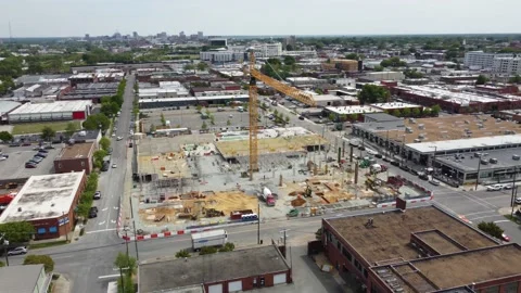 Drone shot orbiting around the front of a crane on construction job site. Stock Footage 161421947