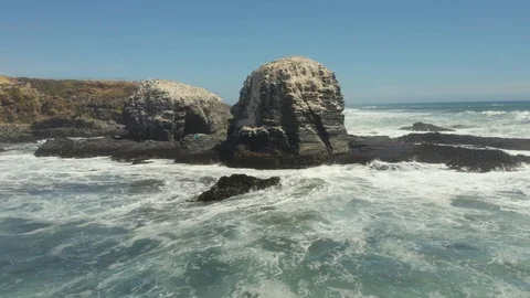 Drone Shot Orbiting Rocks on the Coast of Pichilemu Video stock 100682191