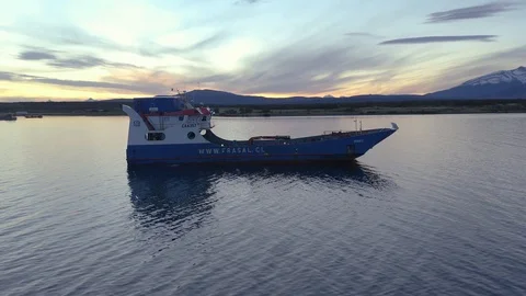 Drone Shot Orbiting a Small Cargo Ship at Sunset Stock Footage 100642896