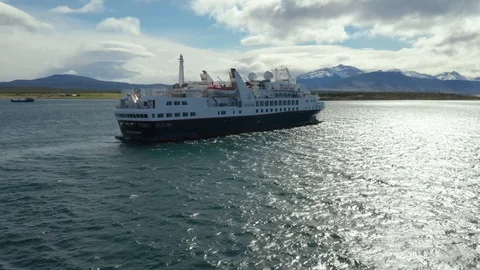 Drone Shot Orbiting a Small Cruise Ship in Puerto Natales Stock Footage 100682319