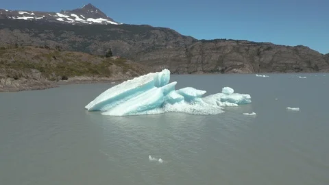 Drone Shot Orbiting a Small Iceberg in a Lake Stock Footage 100682141