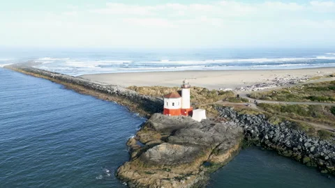 Drone shot orbits north to west around lighthouse along the Coquille river Stock Footage 251756111
