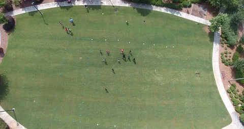 Drone shot over 100 ft looking down at kids playing rugby Stockbeeldmateriaal 100275005