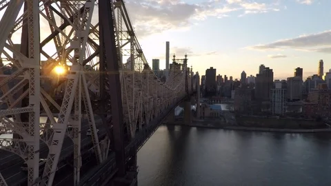 Drone shot over 59th Street Bridge in New York City at sunset Stock Footage