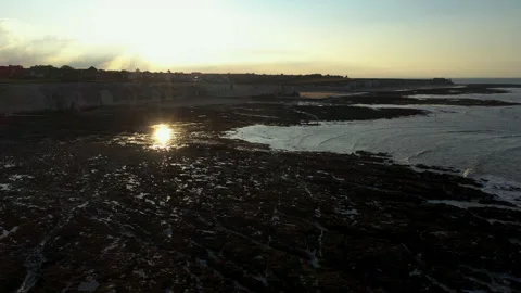 Drone shot over beach at low tide with sun reflection. Stock Footage 146739345