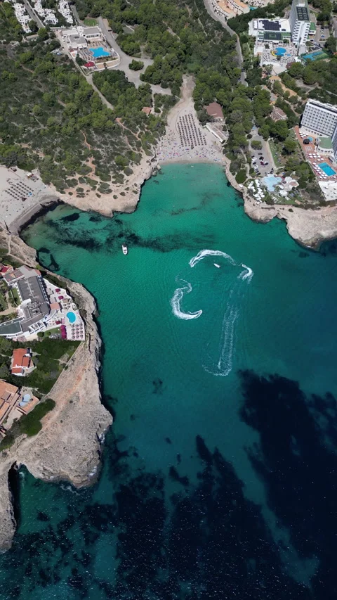 Drone Shot over Cala Murada with cenital view of Watersky, Mallorca, Spain Stock Footage 254571094