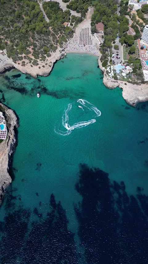 Drone Shot over Cala Murada with cenital view of Watersky, Mallorca, Spain Stock Footage 254573189