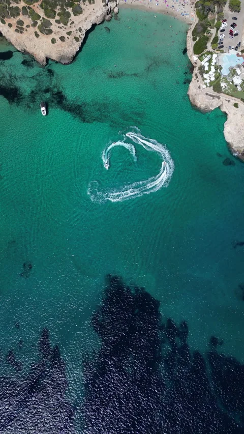 Drone Shot over Cala Murada with cenital view of Watersky, Mallorca, Spain Stock Footage 254577603