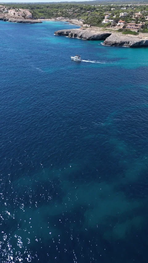Drone Shot over Cala Murada with cenital view of boat, Mallorca, Spain Stock Footage 254580543