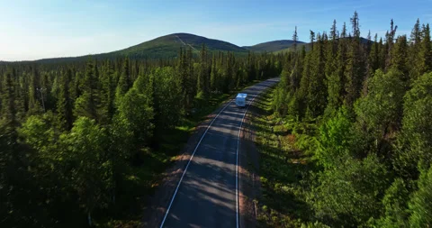Drone shot over a Camper van on a arctic forest road, driving toward Vídeo Stock 275269014