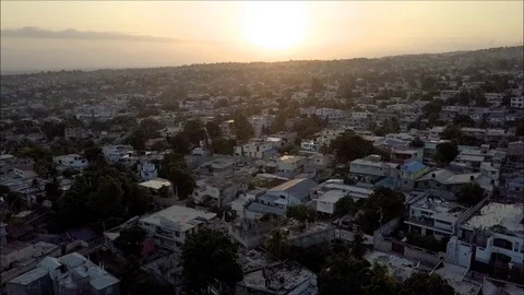Drone shot over city on the side of a mountain at sunset. Haiti Stock Footage