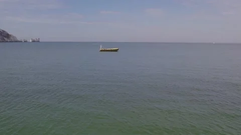 Drone shot over clear blue waters flying towards empty speed boat Stock Footage 167769477