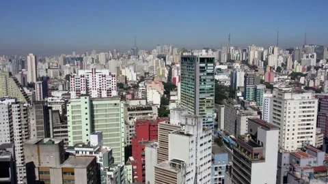 Drone shot over the dense concrete cityscape of sunny Sao Paulo city, Vidéo 241965500