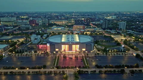 Drone shot over the evening lit United Center, gloomy dusk in Chicago, USA Stock Footage 252185422