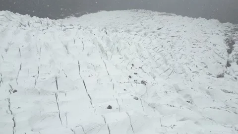 Drone shot over the expansive, deeply crevassed ice fields of Passu Cones Stock Footage 342072700