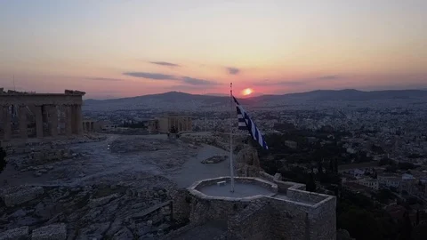 Drone shot over Greek flag on Acropolis in Athens. Sunset sky Stock Footage