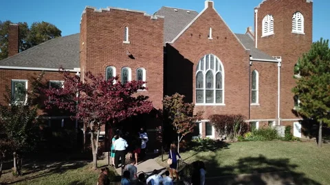 Drone shot over local people entering a church in Tulsa, Oklahoma, USA Stock Footage 220403602