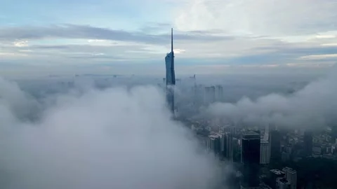 Drone shot over low cloud toward PNB 118 Warisan Merdeka Tower Stock Footage 229064410