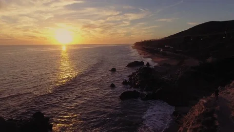 Drone shot over Malibu beach rocks by the ocean Rec709 Stock Footage 84538475